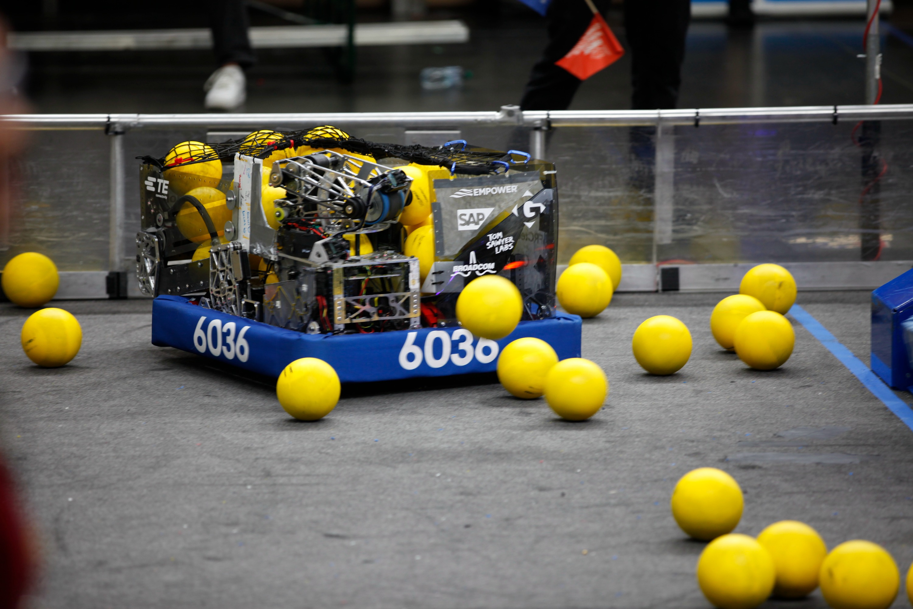 FRC 6036 robot surrounded by yellow balls
